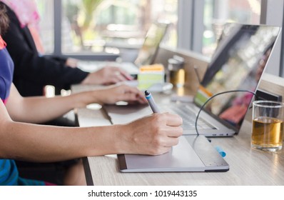 A creative business writes something on notepad. To check the information during lunch break in the coffee room. - Powered by Shutterstock