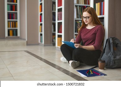 Creative Caucasian Girl Student Sitting On The Floor At Library, Writing Essay, Free Space