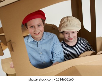 Creative Children Plays In Cardboard Car Playhouse.