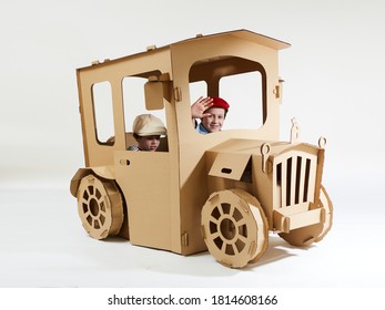 Creative Children Plays In Cardboard Car Playhouse.