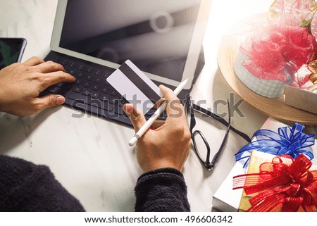 Creative choosing gift with laptop computer and smart phone on mable desk,filter film effect
