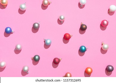 Creative Christmas baubles decoration pattern with pink background. Minimal flat lay concept.