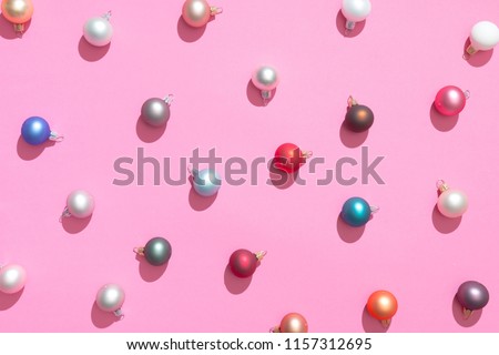 Creative Christmas baubles decoration pattern with pink background. Minimal flat lay concept.