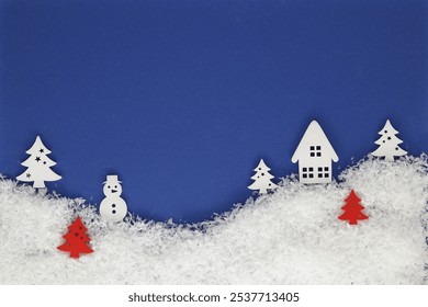 Creative Christmas card with winter snowy landscape with cottage, trees and snowman - Powered by Shutterstock