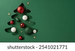 A creative Christmas tree cutout with red, green, and white baubles and gold stars on a green background. Perfect for holiday themes