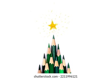 A creative Christmas tree made green pencils white background  yellow star made shavings the top Christmas   New Year flat lay 