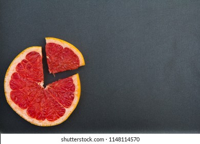 Creative Citrus Bright Colorful Grapefruit Pie Chart Diagram. Top View Food Isolated On Dark Grey Kitchen Table Background. Round Shape Wallpaper. Summer Citrus Harvest. Fruit Salad Ingredient.