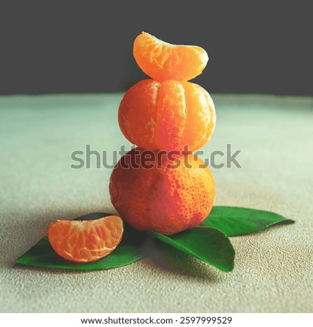 Creative citrus stack with fresh tangerines, beautifully arranged with green leaves. A vibrant and artistic food concept perfect for wellness, healthy eating, and organic lifestyle themes.