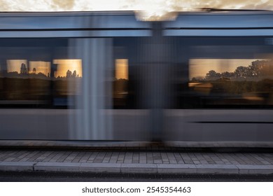 Creative cityscape. Abstract view of a partial landscape through blurred tram windows on motion