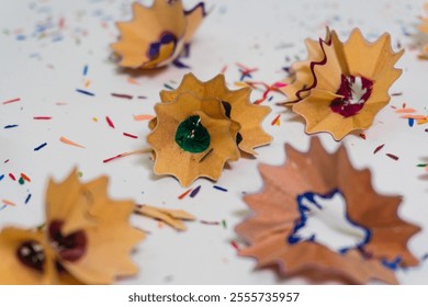 Creative close-up of colorful pencil shavings on a white background, symbolizing art, creativity, and inspiration - Powered by Shutterstock