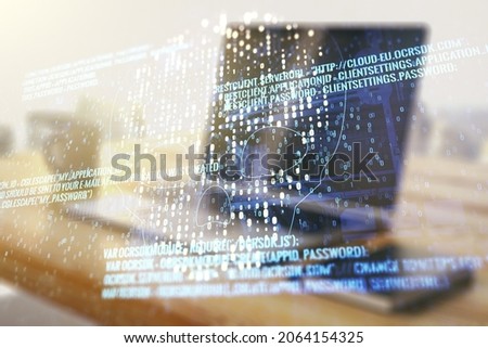 Creative code skull hologram and modern desktop with pc on background, cybercrime and hacking concept. Multiexposure