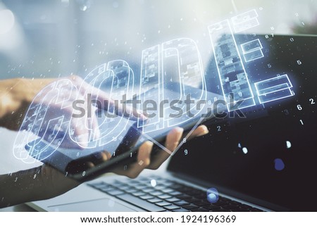Creative Code word hologram and finger clicks on a digital tablet on background, artificial intelligence and neural networks concept. Multiexposure
