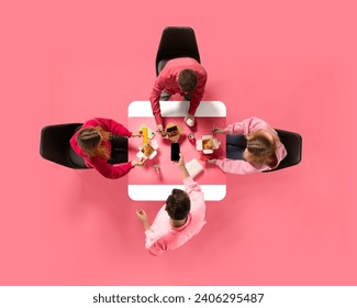 Creative collage. Aerial view of young people, colleagues eating delivery food against pink background. Copy space. Concept of business lunch, morning meeting, briefing. Ad - Powered by Shutterstock