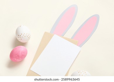 Creative composition with blank card and Easter eggs on beige background