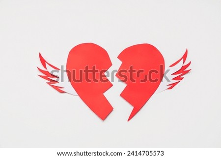 Creative composition with broken paper heart on white background. Valentine's day