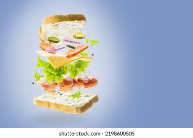 Creative Composition. Classic American Sandwich On A Light Blue Background In Frozen Flight. Minimalism. There Are No People In The Photo. There Is Free Space To Insert.