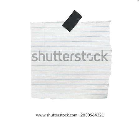 Creative composition featuring dark block on torn lined paper sheet with rectangular object placed