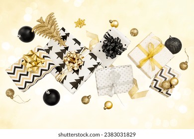 Creative composition of festive present boxes. Free levitation. Black and gold colors