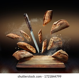 Creative Composition Of Flying Bread, Flour, Crumbs And A Knife