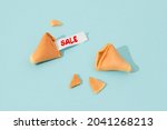 Creative composition with fortune cookie and paper with text on blue background