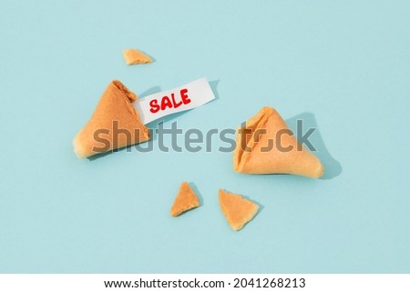 Creative composition with fortune cookie and paper with text on blue background