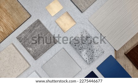 creative composition of interior material samples contains panels and tiles. stylish interior moodboard including terrazzo, quartz, stone tiles, blue laminated, wooden flooring tiles, gold stainless.