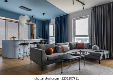 Creative composition of kitchen and living room interior with gray sofa, marble kitchen island, black coffee table, curtain, modern sculpture, gray rug and personal accessories. Home decor. Template. - Powered by Shutterstock