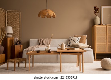 Creative composition of living room interior with modular sofa, wooden coffee table, rattan sideboard, beige rug, pillows and personal accessories. Home decor. Template. 