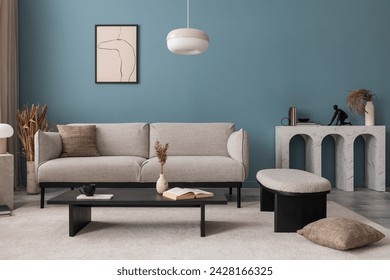Creative composition of living room interior with mock up poster frame, grey sofa, black coffee table, blue wall, stylish furnitures, decorations and personal accessories. Template. Home decor.	
