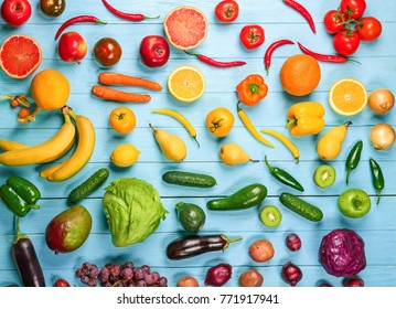 Creative Composition Made Of Fruits And Vegetables In Rainbow Colors On Wooden Background, Flat Lay