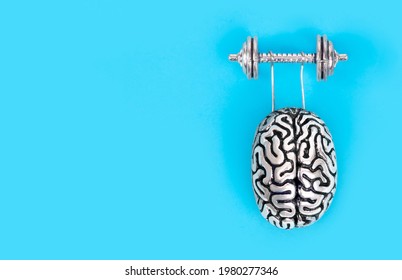 Creative Composition Made Of A Steel Copy Of The Human Brain Lifting A Heavy Dumbbell. Brain Workout Concept.