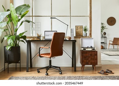 Creative Composition Of Modern Masculine Home Office Workspace Interior With Black Industrial Desk, Brown Leather Armchair, Laptop, Vintage Record Player And Stylish Personal Accessories. Template.