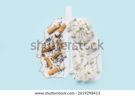 Creative composition with paper lungs, flowers and cigarette butts on color background. No Tobacco Day concept