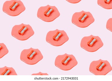 Creative Composition Pattern With Melting Red Pencil Sharpeners On Pastel Pink Background. Surreal Office Or School Idea.