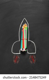 Creative composition with pencils and clips on dark background