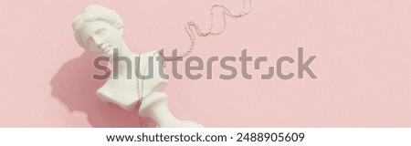 Creative composition with pendant on pink background. Trendy jewelry in minimalist style