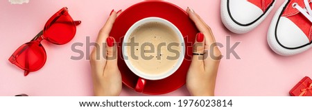 Creative composition with red sneakers, cosmetics and accessory