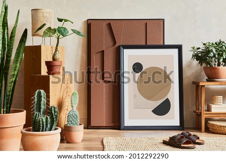 Creative composition of stylish living room interior with mock up poster frame, structure painting, cacti and personal accessories. Plant love and nature concept. Template.
