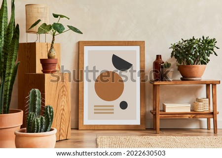 Creative composition of stylish living room interior with mock up poster frame, wooden shelf, cubes, cacti and personal accessories. Plant love and nature concept. Template.