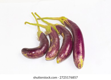 Creative composition of two crossing eggplants, representing health treatment, urology concepts, or creative food art.