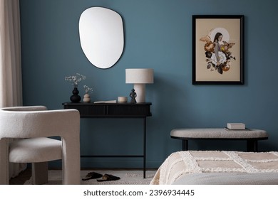 Creative composition of warm bedroom interior with mock up poster frame, blue wall, gray bedding, stylish armchair, bench, slippers, black desk, lamp and personal accessories. Home decor. Template.