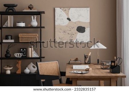 Creative composition of warm and cozy office interior with mock up poster frame, wooden desk, rattan chair, stylish lamp, black rack, books and office accessories. Home decor. Template.