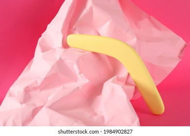 Creative Composition With Yellow Wooden Boomerang On Pink Background