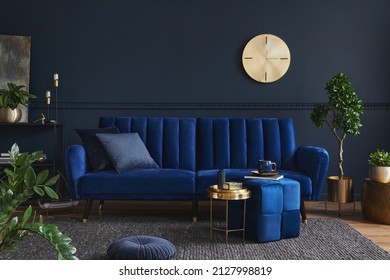 Creative Compositon Of Modern Living Room Interior Design With Glamour Blue Sofa, Metal Shelf, Coffee Table And Elegant Home Accessories. Dark Blue Wall. Home Staging. Template. Copy Space.
