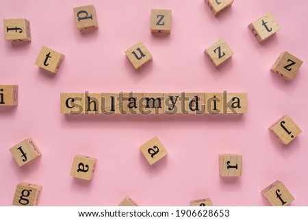 Creative concept Chlamydia word on wooden block. Flat lay.