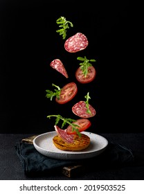 Creative Concept With Falling Food On Black Backdrop