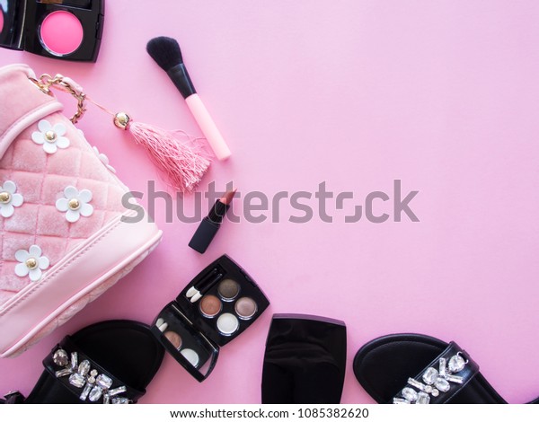 Creative\
concept flat lay of makeup fashion accessories, shoes and bag on\
pink baceground with copy space, minimal\
style.