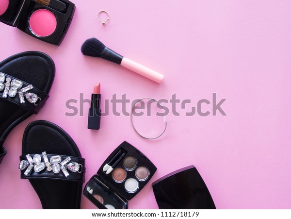 Creative\
concept flat lay of makeup fashion accessories, shoes and bag on\
pink baceground with copy space, minimal\
style.