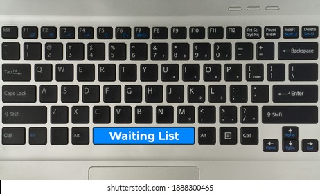 Creative concept flat lay view 'waiting list' word on computer keyboard.