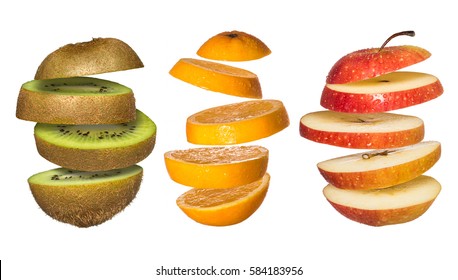 Creative Concept With Flying Fruits. Sliced Orange, Kiwi, Apple Isolated On White. Levity Fruit Floating In The Air.